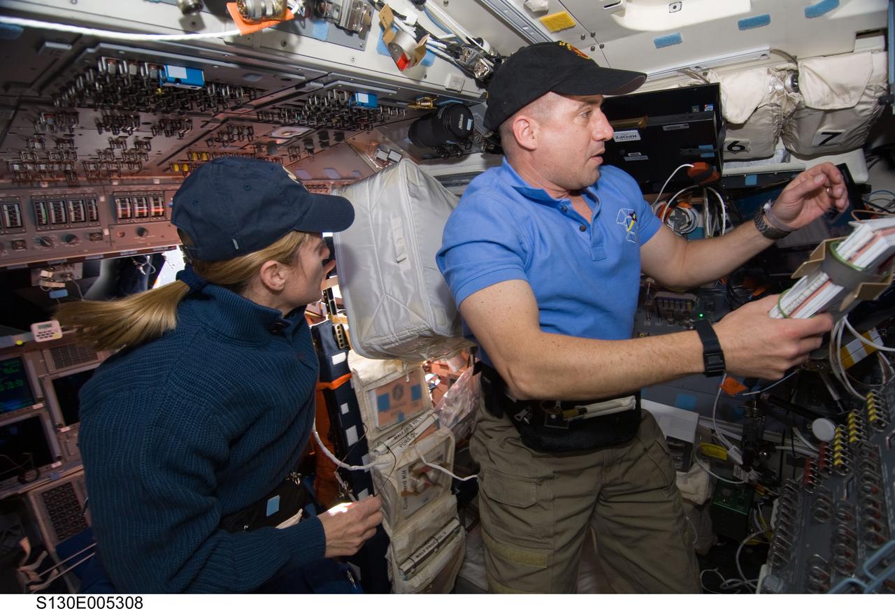 S130-E-005308 (8 Feb. 2010) --- NASA astronauts George Zamka, STS-130 commander; and Kathryn Hire, mission specialist, work on the aft flight deck of space shuttle Endeavour during flight day one activities.