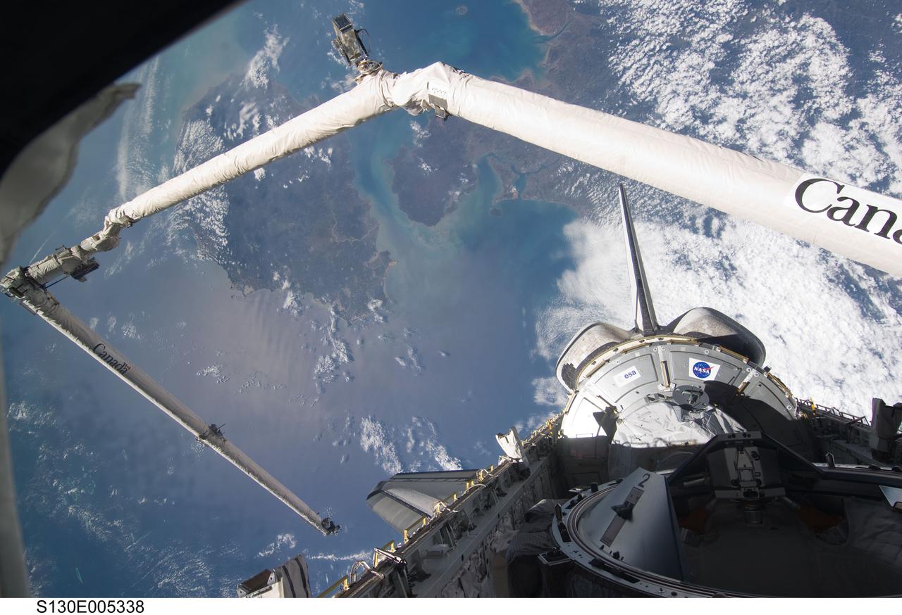 S130-E-005338 (8 Feb. 2010) --- Backdropped by the South China Sea and the Gulf of Tonkin, the Tranquility node in space shuttle Endeavour’s payload bay, vertical stabilizer, orbital maneuvering system (OMS) pods and a shadow-covered docking mechanism are featured in this image photographed by the STS-130 crew from an aft flight deck window. Hainan Island  can be seen between the South China Sea (bottom) and Gulf of Tonkin (top).  The Leizhou Peninsula of the Chinese mainland is on the upper right.