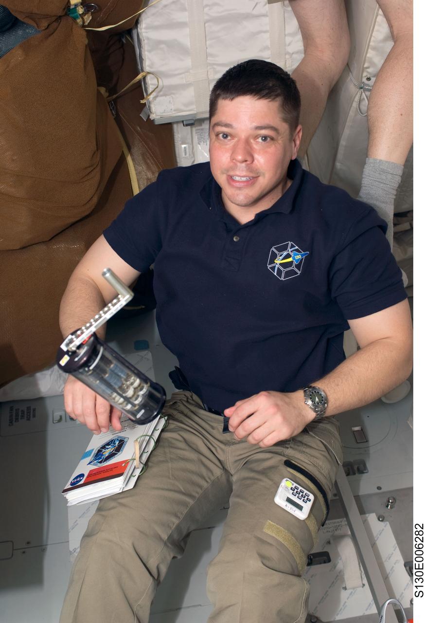 S130-E-006282 (9 Feb. 2010) --- Astronaut Robert Behnken, STS-130 mission specialist, works with a Fluid Processing Apparatus, which is part of the Microbe Group Activation Pack, on the middeck of space shuttle Endeavour during flight day two activities.