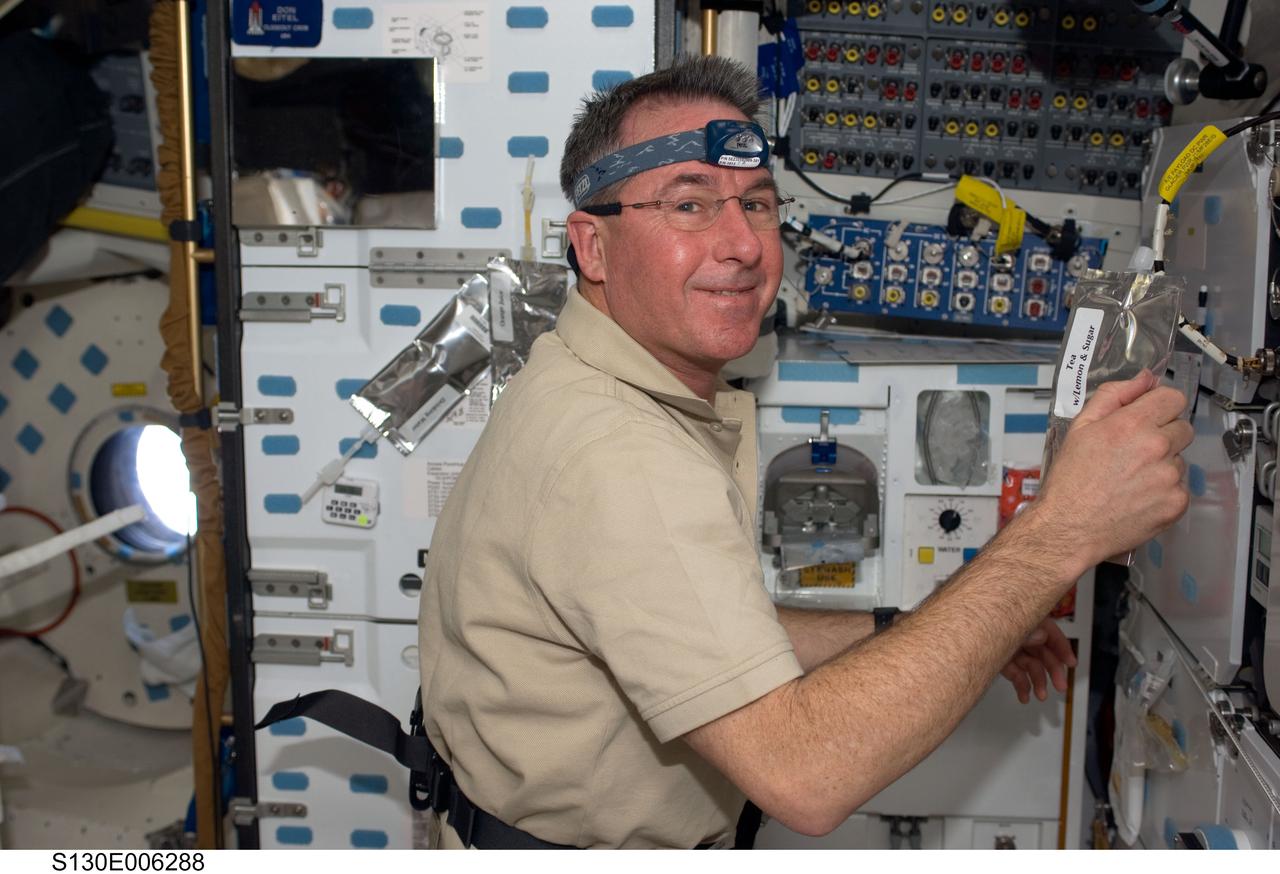S130-E-006288 (9 Feb. 2010) --- Astronaut Stephen Robinson, STS-130 mission specialist, is pictured near the galley on the middeck of the Earth-orbiting space shuttle Endeavour during flight day two activities.