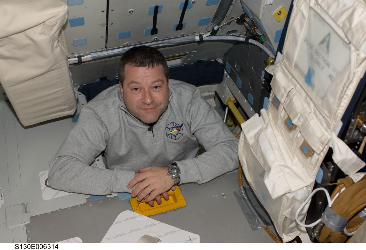 S130-E-006314 (9 Feb. 2010) --- NASA astronaut Nicholas Patrick, STS-130 mission specialist, is pictured in the hatch which connects the flight deck and middeck of space shuttle Endeavour during flight day two activities.