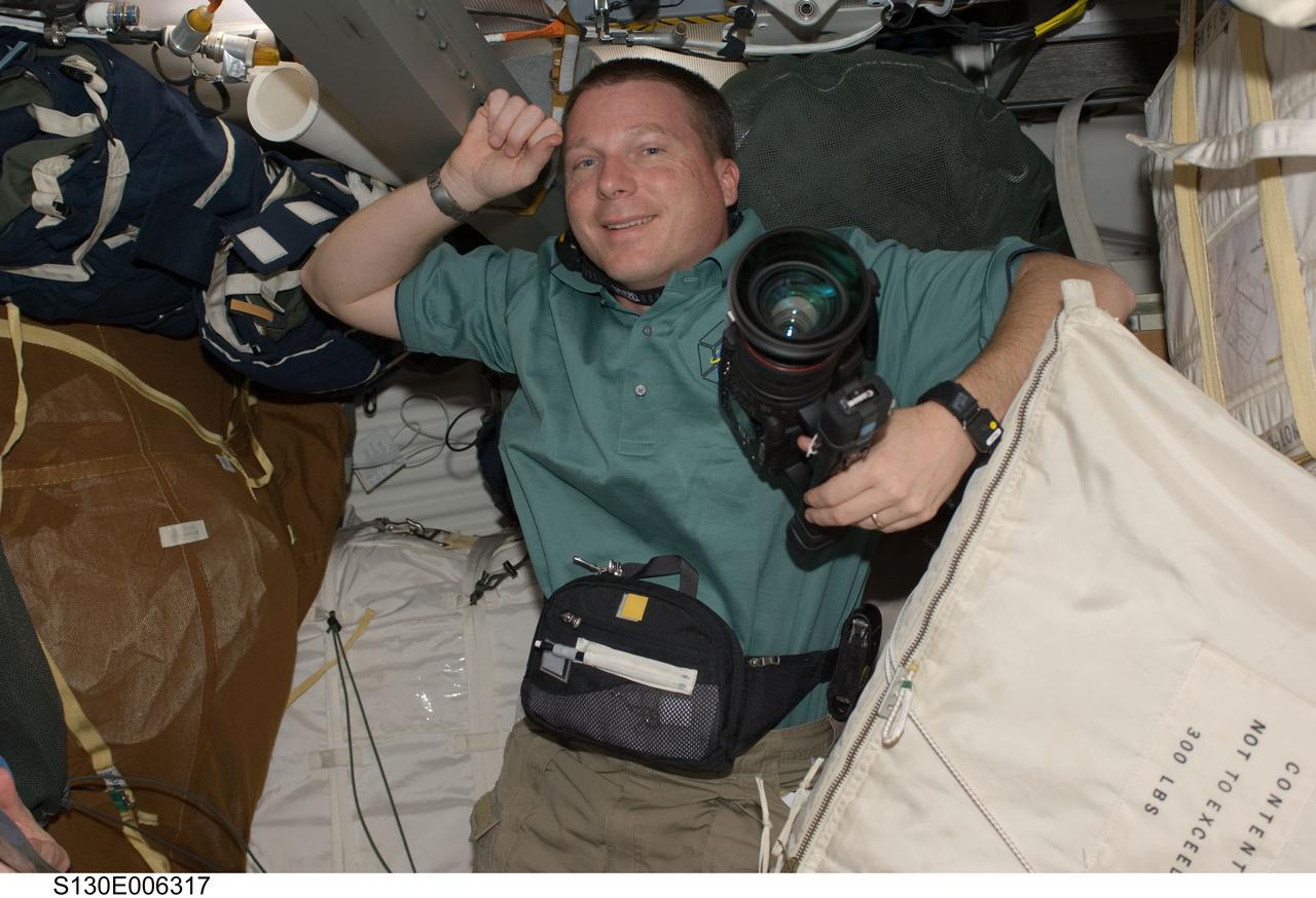 S130-E-006317 (9 Feb. 2010) --- NASA astronaut Terry Virts, STS-130 pilot, holds a video camera on the middeck of space shuttle Endeavour during flight day two activities.