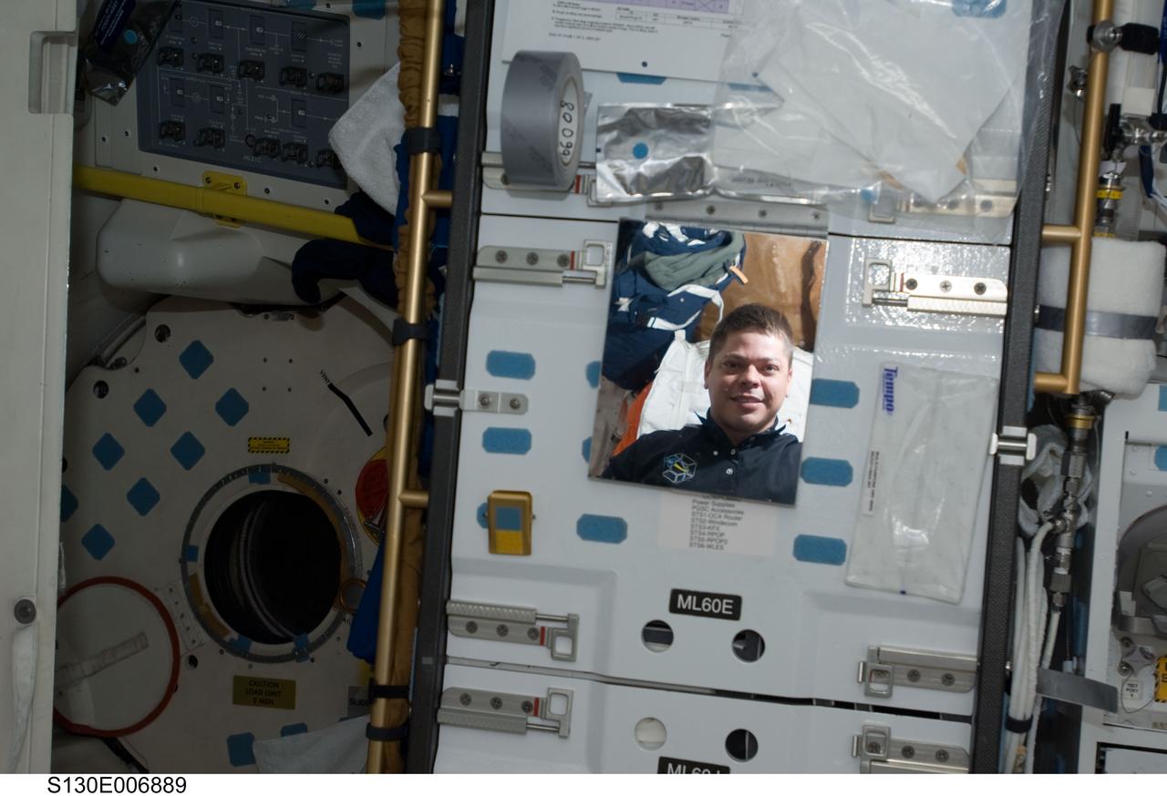 S130-E-006889 (10 Feb. 2010) --- NASA astronaut Robert Behnken, STS-130 mission specialist, is pictured in the reflection of a mirror on the middeck of space shuttle Endeavour while docked with the International Space Station.