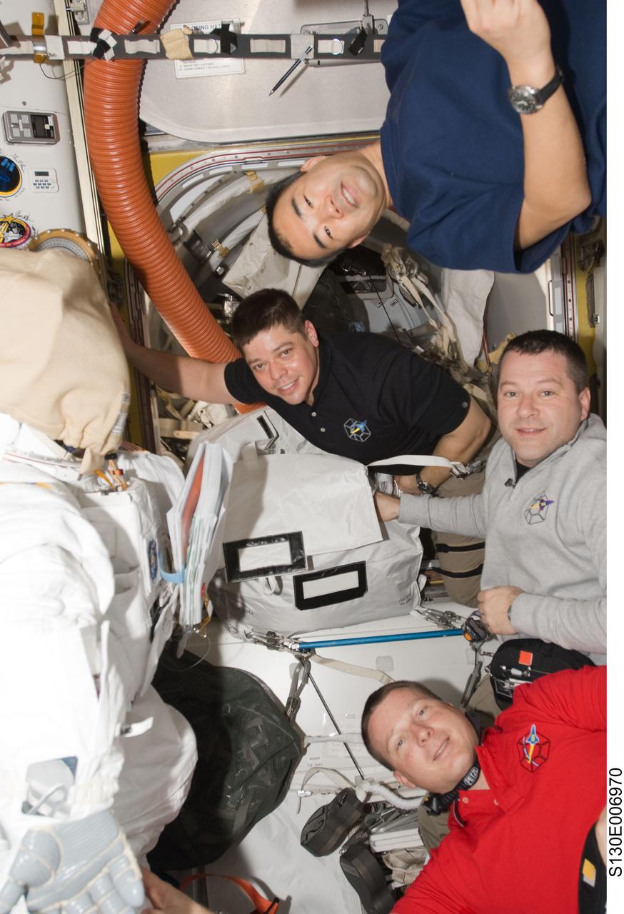 S130-E-006970 (10 Feb. 2010) --- NASA astronauts Terry Virts (bottom), STS-130 pilot; Nicholas Patrick (right) and Robert Behnken, both STS-130 mission specialists; along with Japan Aerospace Exploration Agency (JAXA) astronaut Soichi Noguchi (top), Expedition 22 flight engineer, are pictured in the Quest airlock of the International Space Station while space shuttle Endeavour remains docked with the station. An empty Extravehicular Mobility Unit (EMU) spacesuit is at left.