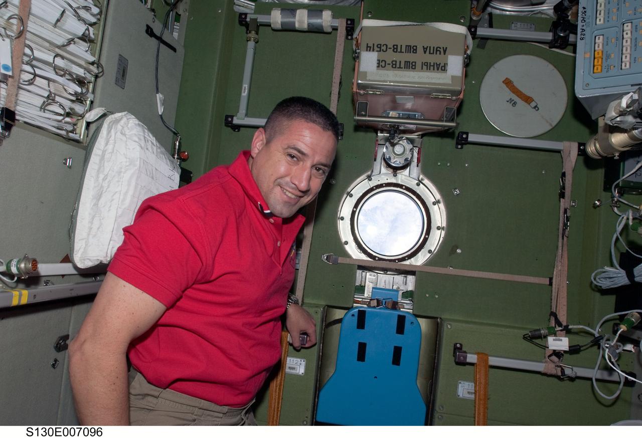 S130-E-007096 (11 Feb. 2010) --- NASA astronaut George Zamka, STS-130 commander, is pictured near a window in the Zvezda Service Module of the International Space Station while space shuttle Endeavour remains docked with the station.