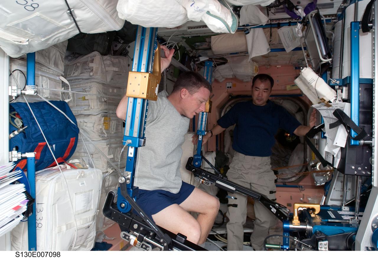 S130-E-007098 (11 Feb. 2010) --- NASA astronaut Terry Virts, STS-130 pilot, exercises using the advanced Resistive Exercise Device (aRED) in the Unity node of the International Space Station while space shuttle Endeavour remains docked with the station. Japan Aerospace Exploration Agency (JAXA) astronaut Soichi Noguchi, Expedition 22 flight engineer, is in the background.