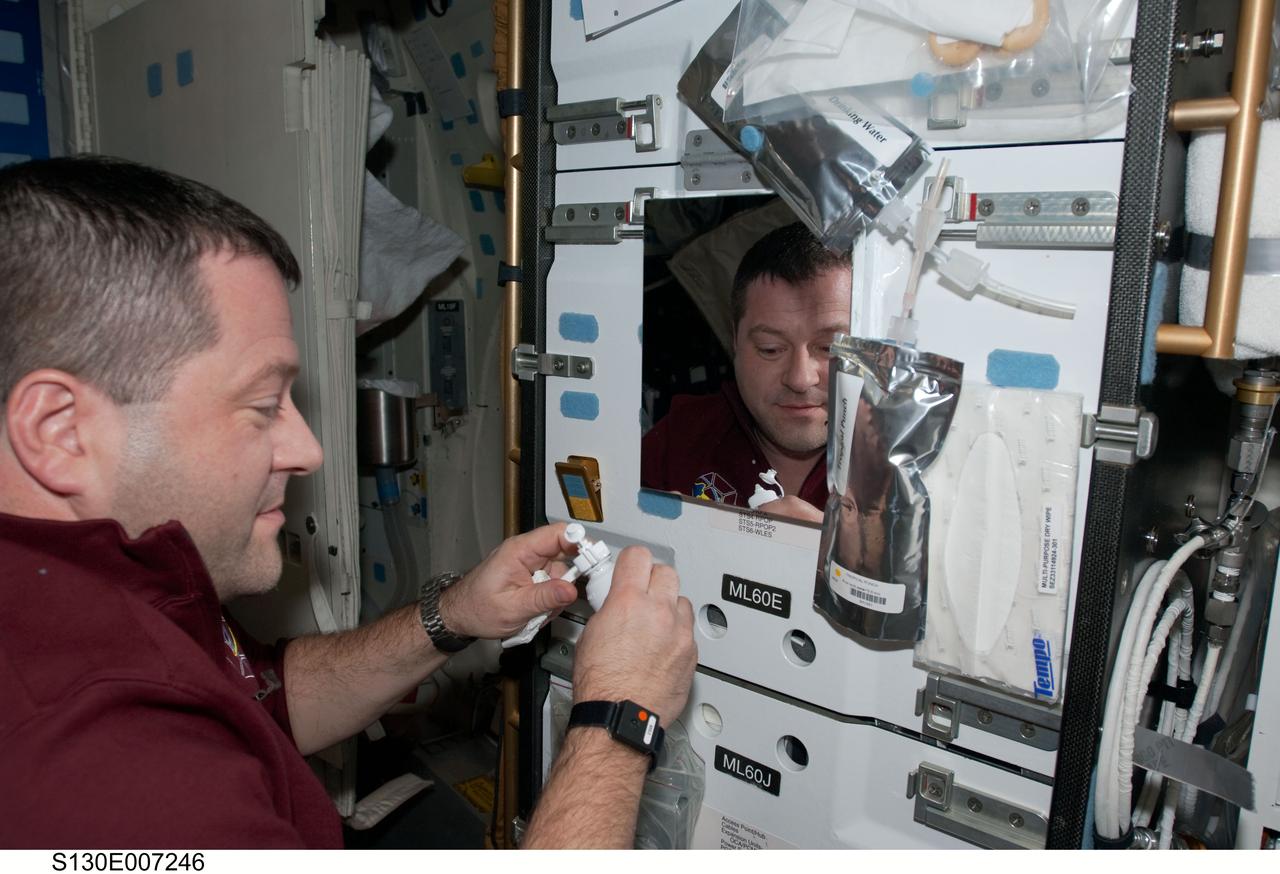 S130-E-007246 (11 Feb. 2010) --- NASA astronaut Nicholas Patrick, STS-130 mission specialist, is pictured near a mirror on the middeck of space shuttle Endeavour while docked with the International Space Station.