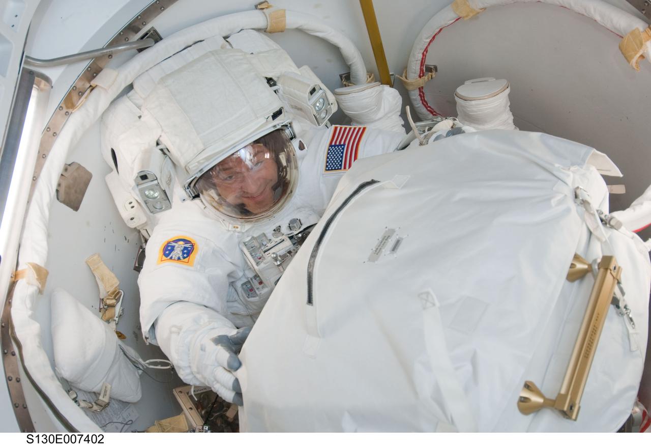 S130-E-007402 (11 Feb. 2010) --- NASA astronaut Nicholas Patrick, STS-130 mission specialist, attired in his Extravehicular Mobility Unit (EMU) spacesuit, prepares to exit the Quest airlock of the International Space Station to begin the mission’s first session of extravehicular activity (EVA).