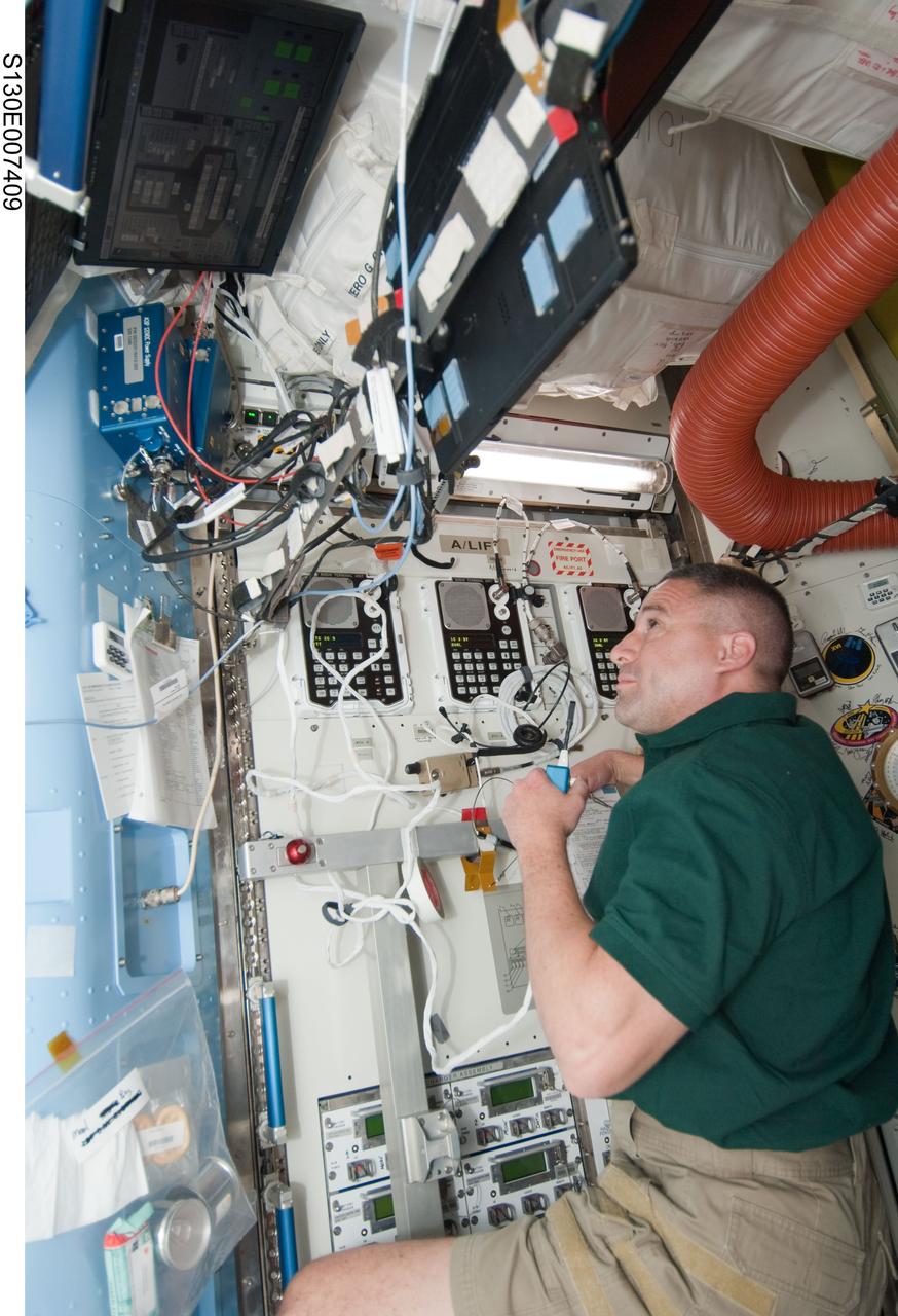 S130-E-007409 (11 Feb. 2010) --- NASA astronaut George Zamka, STS-130 commander, works in the Quest airlock of the International Space Station while space shuttle Endeavour remains docked with the station.