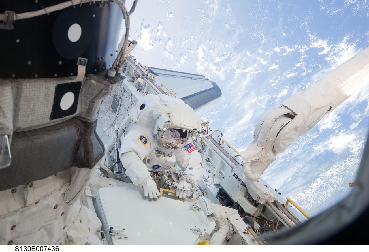 S130-E-007436 (11 Feb. 2010) --- NASA astronaut Nicholas Patrick, STS-130 mission specialist, participates in the mission's first session of extravehicular activity (EVA) as construction and maintenance continue on the International Space Station. During the 6-hour, 32-minute spacewalk, Patrick and astronaut Robert Behnken (out of frame), mission specialist, relocated a temporary platform from the Special Purpose Dexterous Manipulator, or Dextre, to the station’s truss structure and installed two handles on the robot. Once Tranquility was structurally mated to Unity, the spacewalkers connected heater and data cables that will integrate the new module with the rest of the station’s systems. They also pre-positioned insulation blankets and ammonia hoses that will be used to connect Tranquility to the station’s cooling radiators during the mission’s second spacewalk.