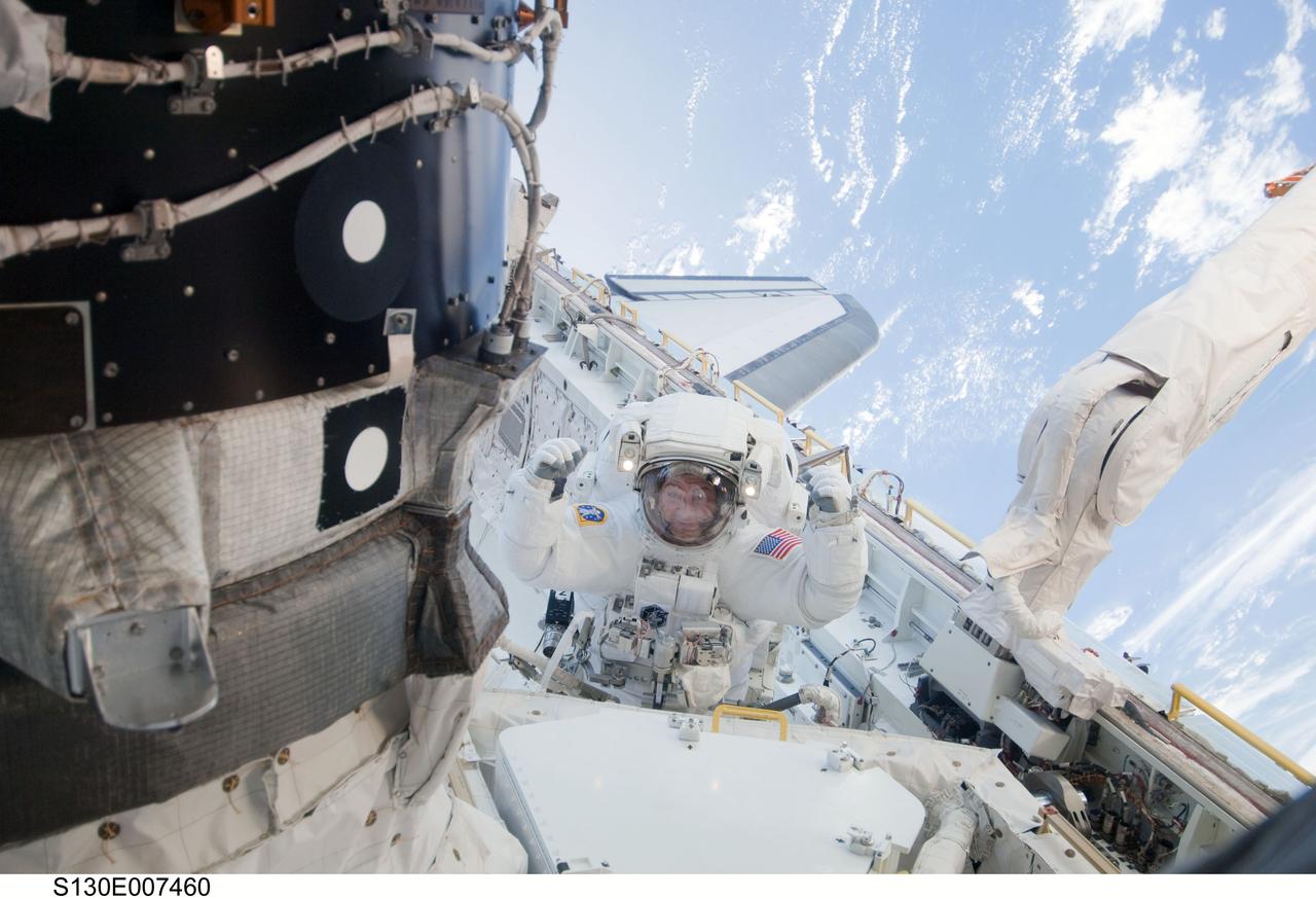 S130-E-007460 (11 Feb. 2010) --- NASA astronaut Nicholas Patrick, STS-130 mission specialist, participates in the mission's first session of extravehicular activity (EVA) as construction and maintenance continue on the International Space Station. During the 6-hour, 32-minute spacewalk, Patrick and astronaut Robert Behnken (out of frame), mission specialist, relocated a temporary platform from the Special Purpose Dexterous Manipulator, or Dextre, to the station’s truss structure and installed two handles on the robot. Once Tranquility was structurally mated to Unity, the spacewalkers connected heater and data cables that will integrate the new module with the rest of the station’s systems. They also pre-positioned insulation blankets and ammonia hoses that will be used to connect Tranquility to the station’s cooling radiators during the mission’s second spacewalk.