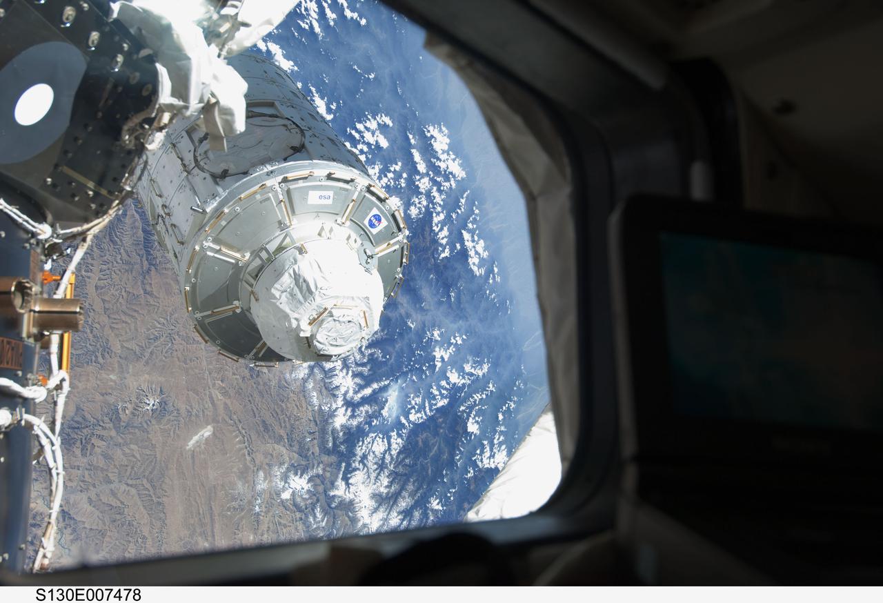 S130-E-007478 (11 Feb. 2010) --- In the grasp of the station’s Canadarm2, the Tranquility module is transferred from its stowage position in space shuttle Endeavour’s (STS-130) payload bay to position it on the port side of the Unity node of the International Space Station. Tranquility was locked in place with 16 remotely-controlled bolts.