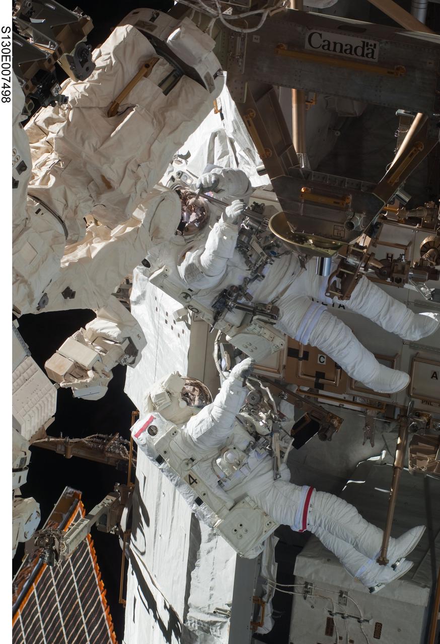 S130-E-007498 (11 Feb. 2010) --- NASA astronauts Robert Behnken (bottom) and Nicholas Patrick, both STS-130 mission specialists, participate in the mission's first session of extravehicular activity (EVA) as construction and maintenance continue on the International Space Station. During the 6-hour, 32-minute spacewalk, Behnken and Patrick relocated a temporary platform from the Special Purpose Dexterous Manipulator, or Dextre, to the station’s truss structure and installed two handles on the robot. Once Tranquility was structurally mated to Unity, the spacewalkers connected heater and data cables that will integrate the new module with the rest of the station’s systems. They also pre-positioned insulation blankets and ammonia hoses that will be used to connect Tranquility to the station’s cooling radiators during the mission’s second spacewalk.
