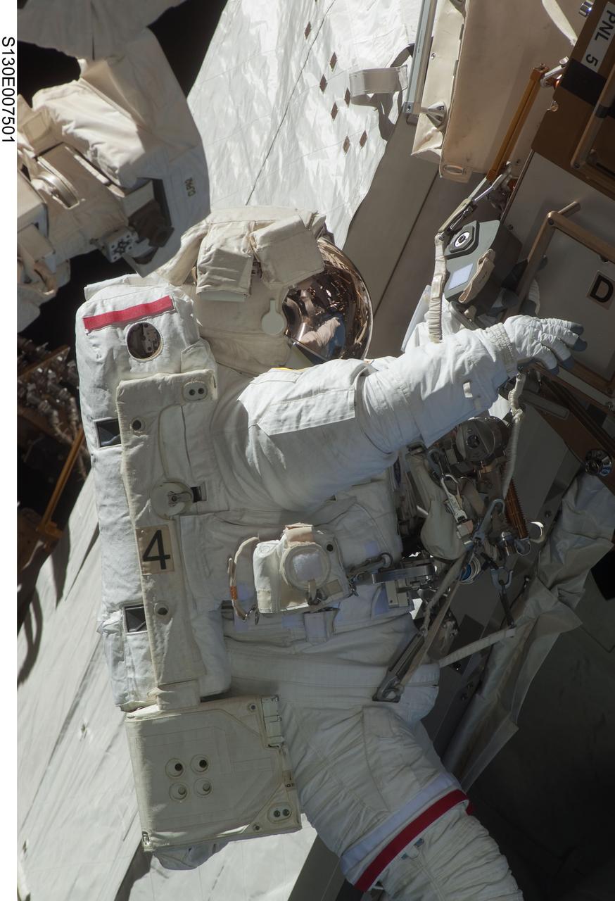 S130-E-007501 (11 Feb. 2010) --- NASA astronaut Robert Behnken, STS-130 mission specialist, participates in the mission's first session of extravehicular activity (EVA) as construction and maintenance continue on the International Space Station. During the 6-hour, 32-minute spacewalk, Behnken and astronaut Nicholas Patrick (out of frame), mission specialist, relocated a temporary platform from the Special Purpose Dexterous Manipulator, or Dextre, to the station’s truss structure and installed two handles on the robot. Once Tranquility was structurally mated to Unity, the spacewalkers connected heater and data cables that will integrate the new module with the rest of the station’s systems. They also pre-positioned insulation blankets and ammonia hoses that will be used to connect Tranquility to the station’s cooling radiators during the mission’s second spacewalk.