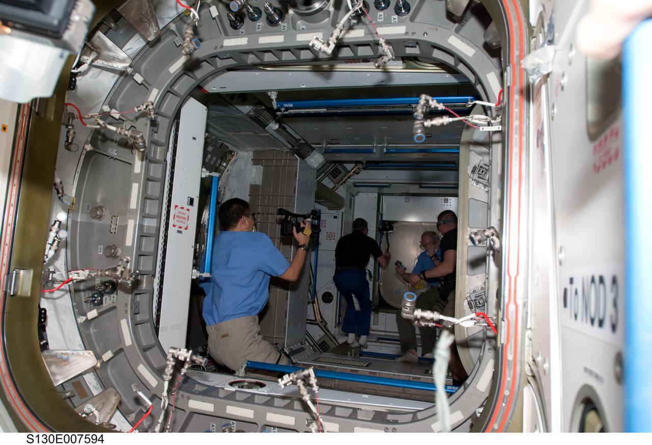 S130-E-007594 (13 Feb. 2010) --- Japan Aerospace Exploration Agency (JAXA) astronaut Soichi Noguchi, Expedition 22 flight engineer, uses a video camera in the newly-installed Tranquility node of the International Space Station while space shuttle Endeavour remains docked with the station. NASA astronauts George Zamka (right), STS-130 commander; Jeffrey Williams (center), Expedition 22 commander; and Stephen Robinson, STS-130 mission specialist, are visible in the background.