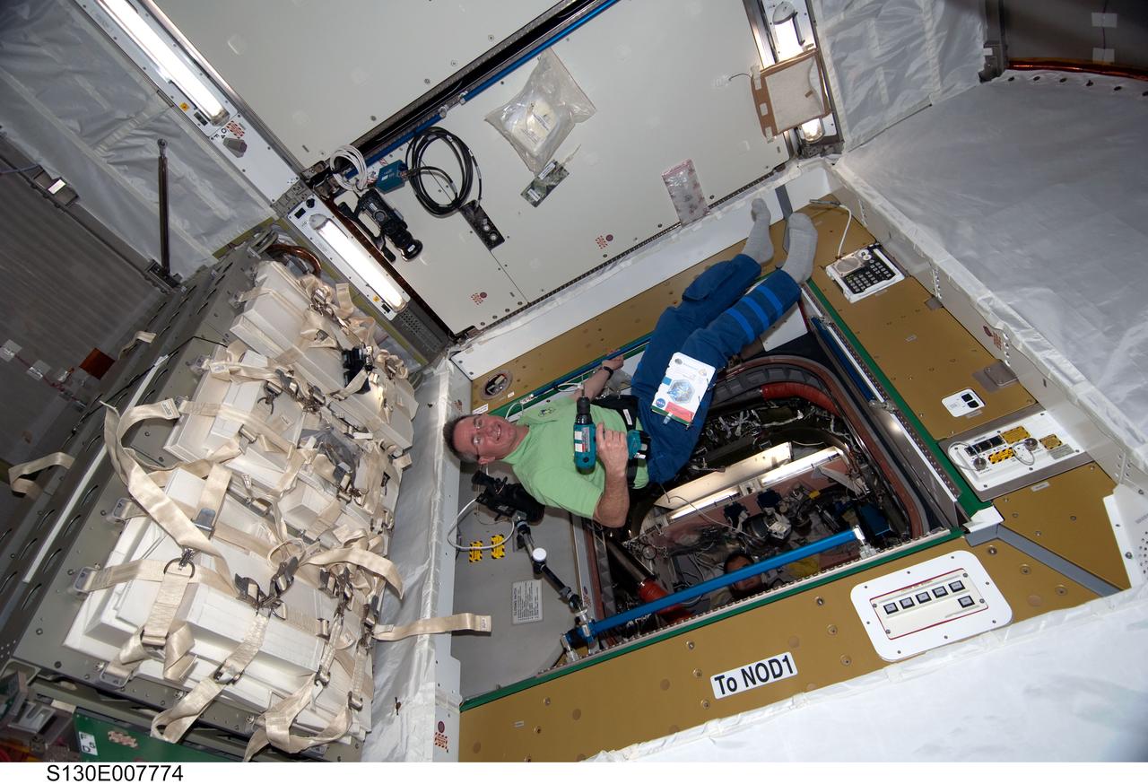 S130-E-007774 (14 Feb. 2010) --- NASA astronaut Stephen Robinson, STS-130 mission specialist, holds a drill while floating freely in the newly-installed Tranquility node of the International Space Station while space shuttle Endeavour remains docked with the station.