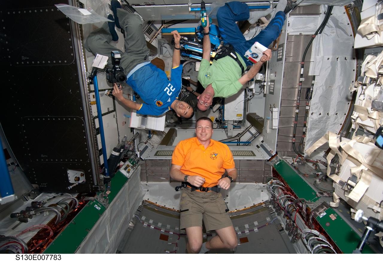 S130-E-007783 (14 Feb. 2010) --- NASA astronauts Terry Virts (bottom), STS-130 pilot; Stephen Robinson (top right), STS-130 mission specialist; and Japan Aerospace Exploration Agency (JAXA) astronaut Soichi Noguchi, Expedition 22 flight engineer, are pictured in the newly-installed Tranquility node of the International Space Station while space shuttle Endeavour remains docked with the station.