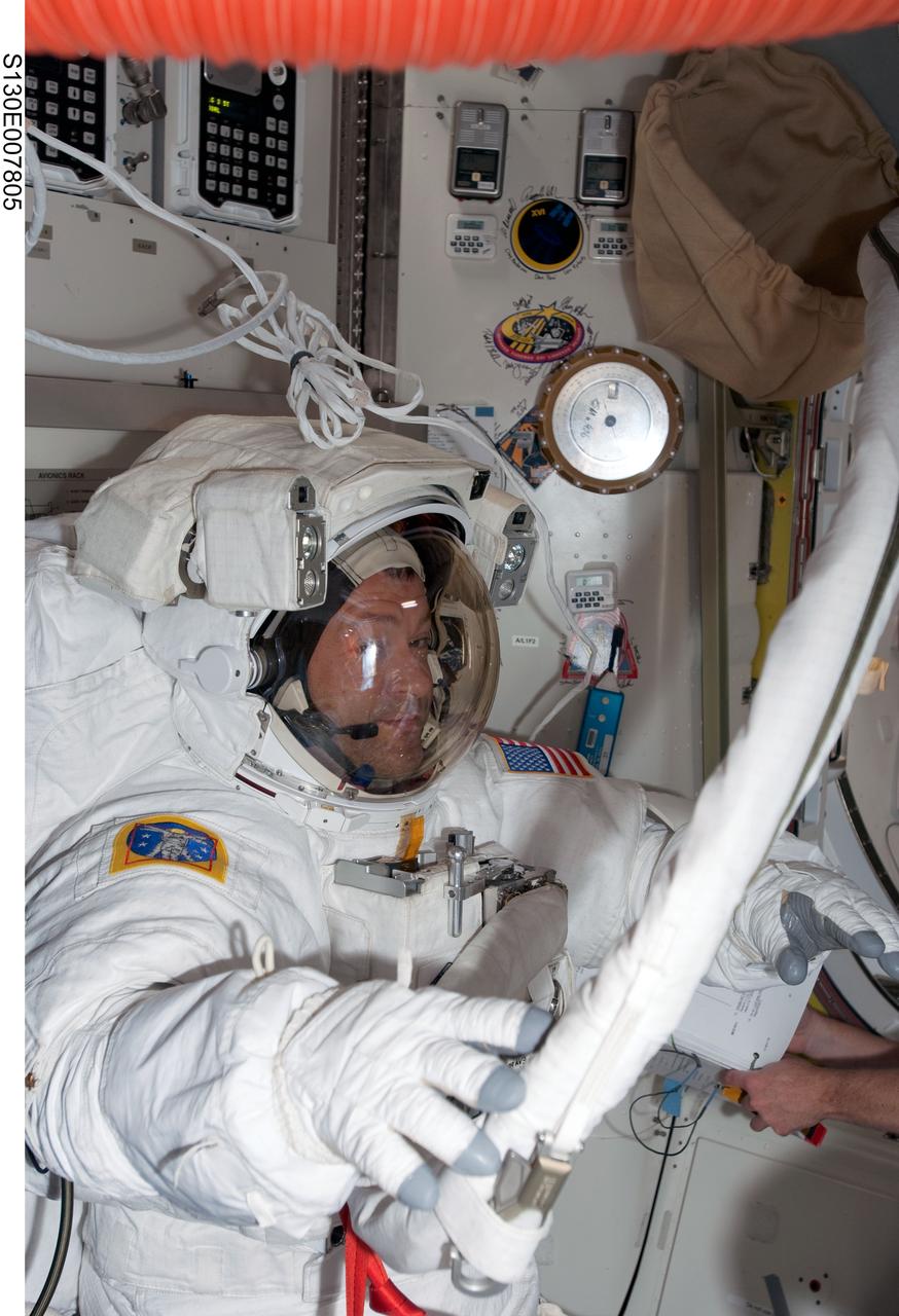 S130-E-007805 (13 Feb. 2010) --- NASA astronaut Nicholas Patrick, STS-130 mission specialist, attired in his Extravehicular Mobility Unit (EMU) spacesuit, is pictured in the Quest airlock of the International Space Station prior to the start of the mission’s second spacewalk.