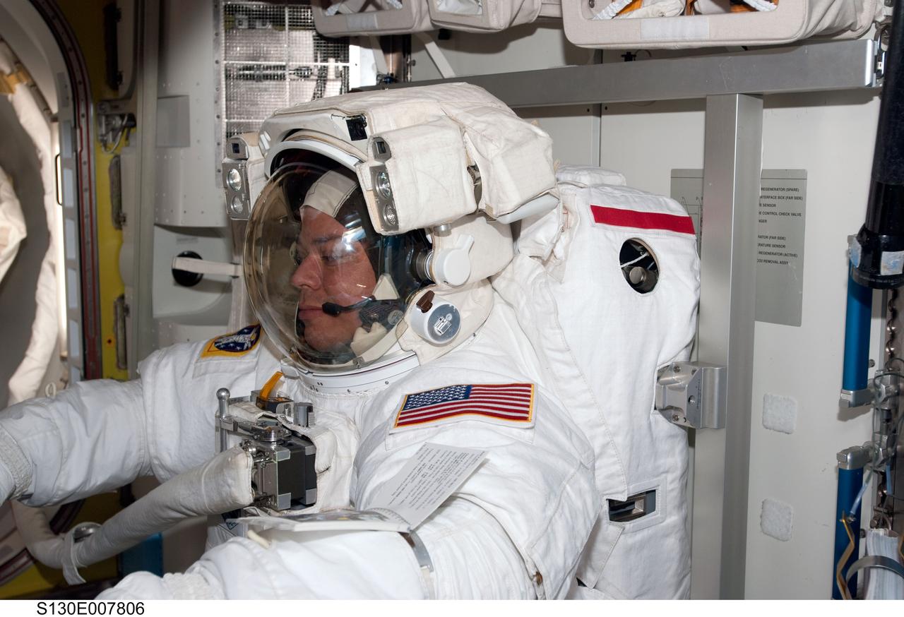 S130-E-007806 (13 Feb. 2010) --- NASA astronaut Robert Behnken, STS-130 mission specialist, attired in his Extravehicular Mobility Unit (EMU) spacesuit, is pictured in the Quest airlock of the International Space Station prior to the start of the mission’s second spacewalk.