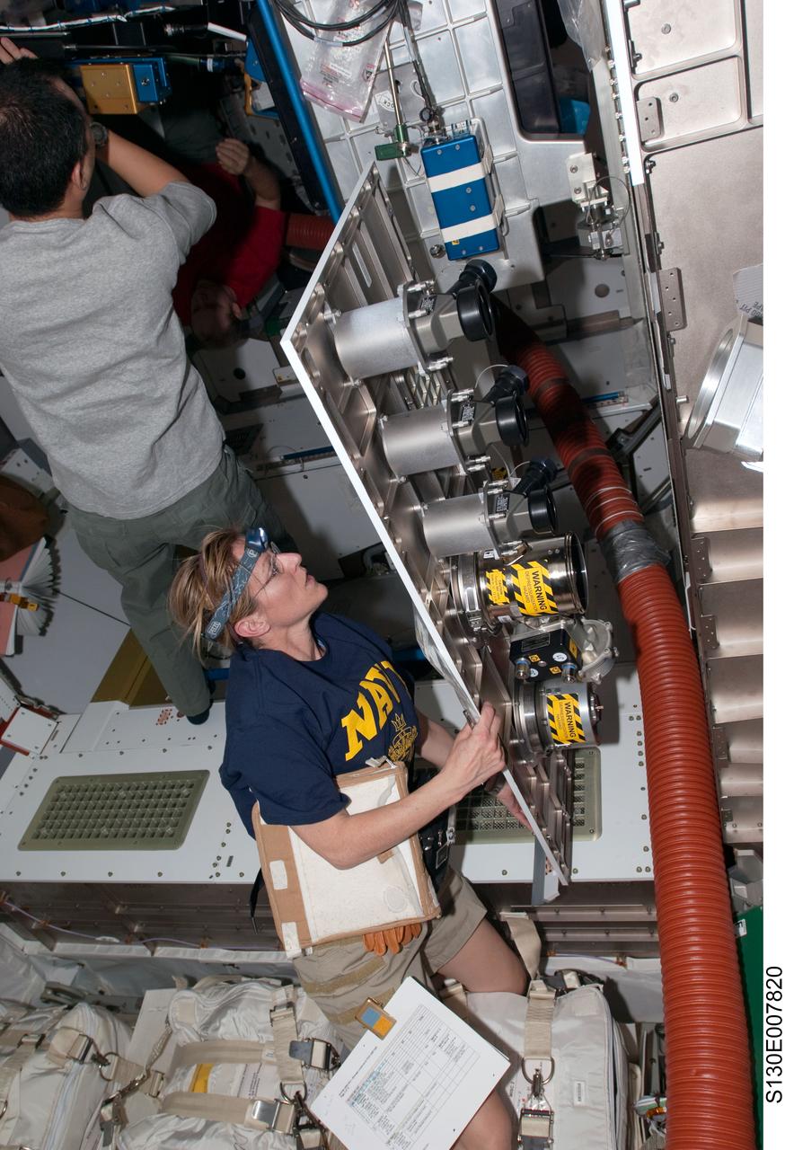 S130-E-007820 (13 Feb. 2010) --- NASA astronaut Kathryn Hire, STS-130 mission specialist, works with hardware in the newly-installed Tranquility node of the International Space Station while space shuttle Endeavour remains docked with the station. Japan Aerospace Exploration Agency (JAXA) astronaut Soichi Noguchi, Expedition 22 flight engineer, is at left.