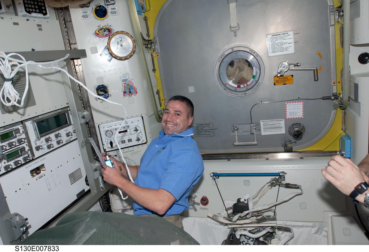 S130-E-007833 (13 Feb. 2010) --- NASA astronaut George Zamka, STS-130 commander, works in the Quest airlock of the International Space Station while space shuttle Endeavour remains docked with the station.