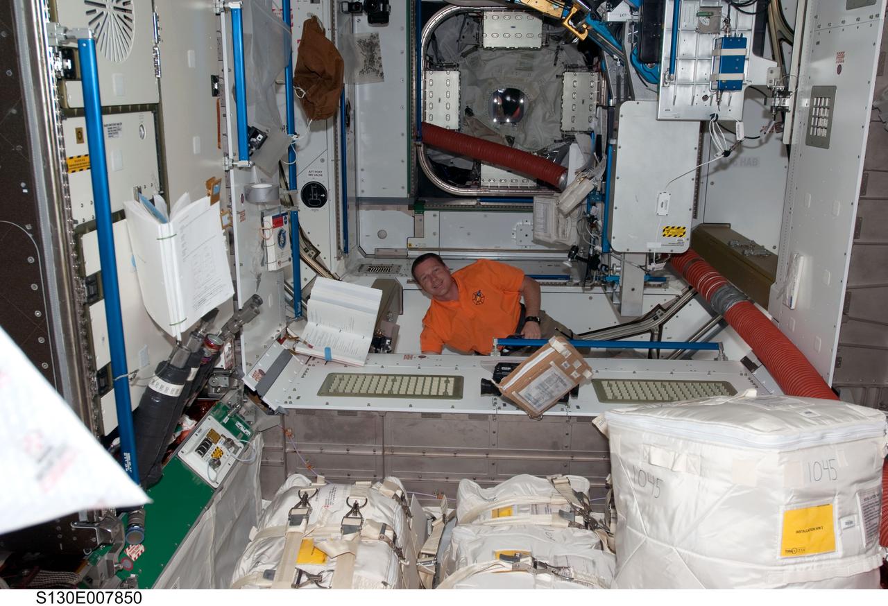 S130-E-007850 (14 Feb. 2010) --- NASA astronaut Terry Virts, STS-130 pilot, works in the newly-installed Tranquility node of the International Space Station while space shuttle Endeavour remains docked with the station.