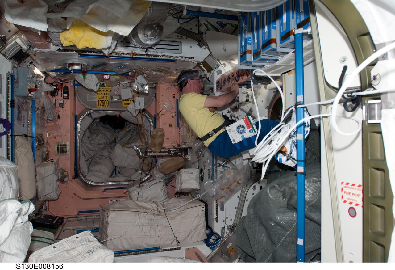 S130-E-008156 (15 Feb. 2010) --- NASA astronaut Stephen Robinson, STS-130 mission specialist, works in the Unity node of the International Space Station while space shuttle Endeavour remains docked with the station.