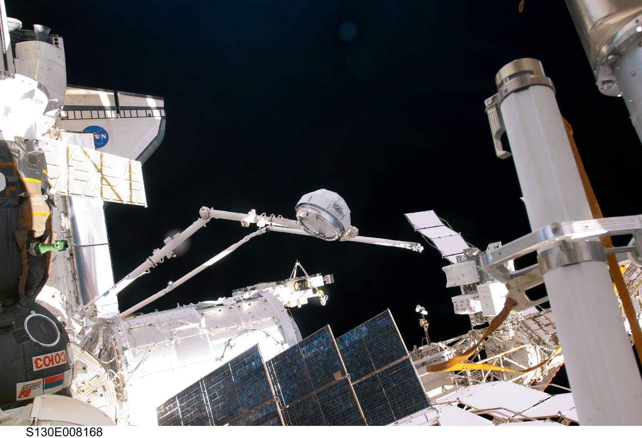 S130-E-008168 (15 Feb. 2010) --- In the grasp of the Canadarm2, the Cupola is relocated from the forward port to the Earth-facing port of the International Space Station’s newly-installed Tranquility node. NASA astronauts Terry Virts, STS-130 pilot; and Kathryn Hire, mission specialist, moved the Cupola, operating the station’s robotic arm from controls inside the Destiny laboratory.