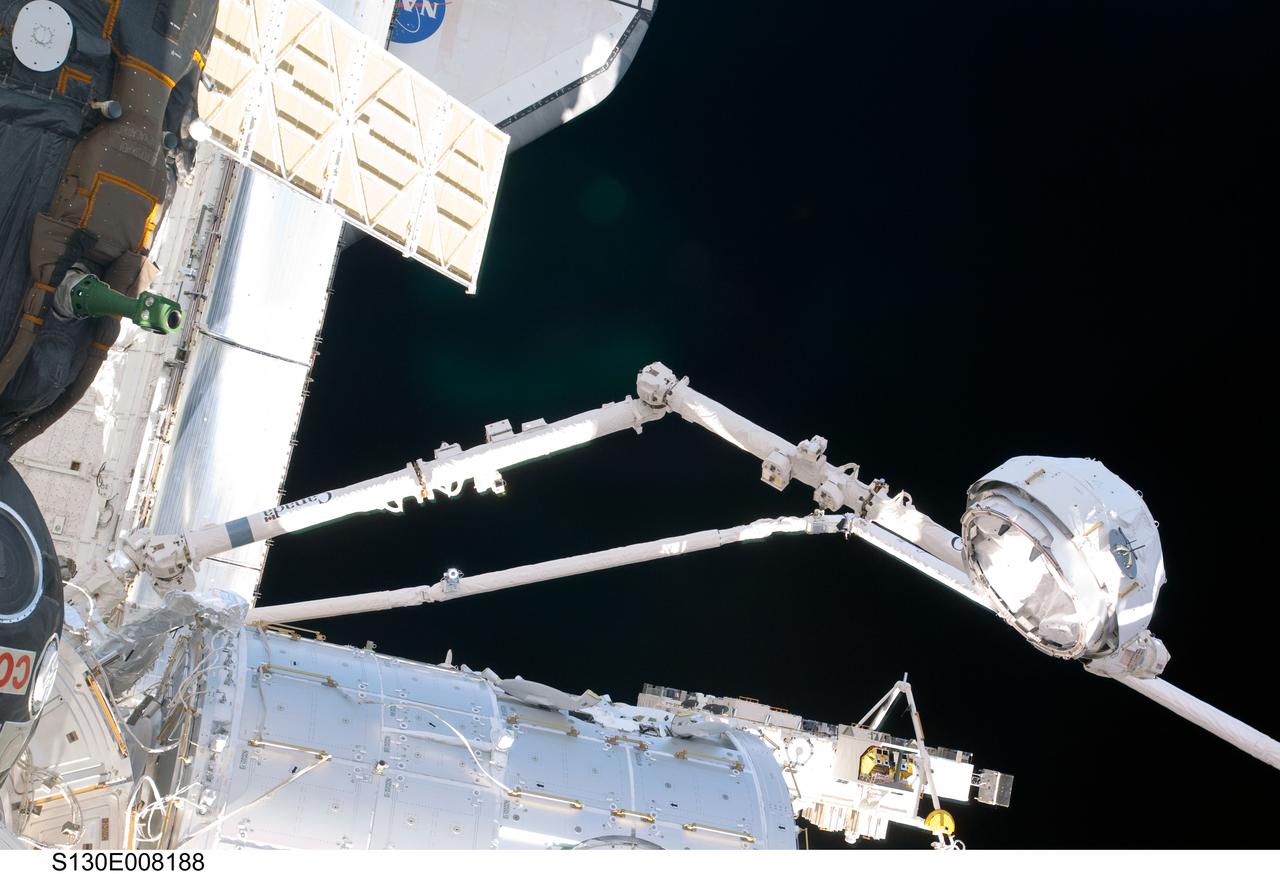 S130-E-008188 (15 Feb. 2010) --- In the grasp of the Canadarm2, the Cupola is relocated from the forward port to the Earth-facing port of the International Space Station’s newly-installed Tranquility node. NASA astronauts Terry Virts, STS-130 pilot; and Kathryn Hire, mission specialist, moved the Cupola, operating the station’s robotic arm from controls inside the Destiny laboratory.