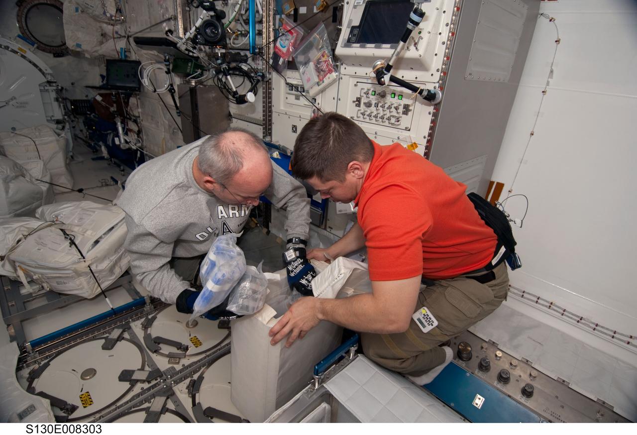 S130-E-008303 (15 Feb. 2010) --- NASA astronauts Jeffrey Williams (left), Expedition 22 commander; and Robert Behnken, STS-130 mission specialist, work in the Kibo laboratory of the International Space Station while space shuttle Endeavour remains docked with the station.
