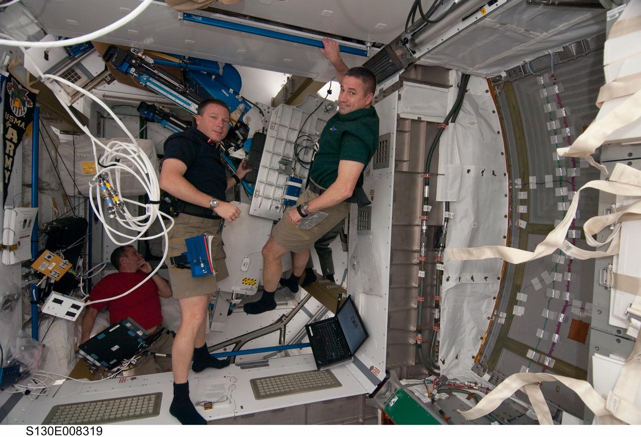 S130-E-008319 (15 Feb. 2010) --- NASA astronauts George Zamka (right), STS-130 commander; Terry Virts, pilot; and T.J. Creamer (background), Expedition 22 flight engineer, work in the newly-installed Tranquility node of the International Space Station while space shuttle Endeavour remains docked with the station.