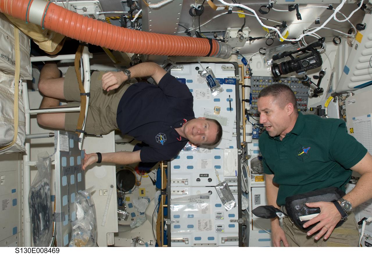 S130-E-008469 (15 Feb. 2010) --- NASA astronauts George Zamka (right), STS-130 commander; and Terry Virts, pilot, are pictured on the middeck of space shuttle Endeavour while docked with the International Space Station.