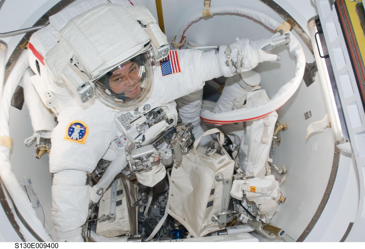 S130-E-009400 (16 Feb. 2010) --- NASA astronaut Robert Behnken, STS-130 mission specialist, attired in his Extravehicular Mobility Unit (EMU) spacesuit, prepares to exit the Quest airlock of the International Space Station to begin the mission's third and final session of extravehicular activity (EVA).