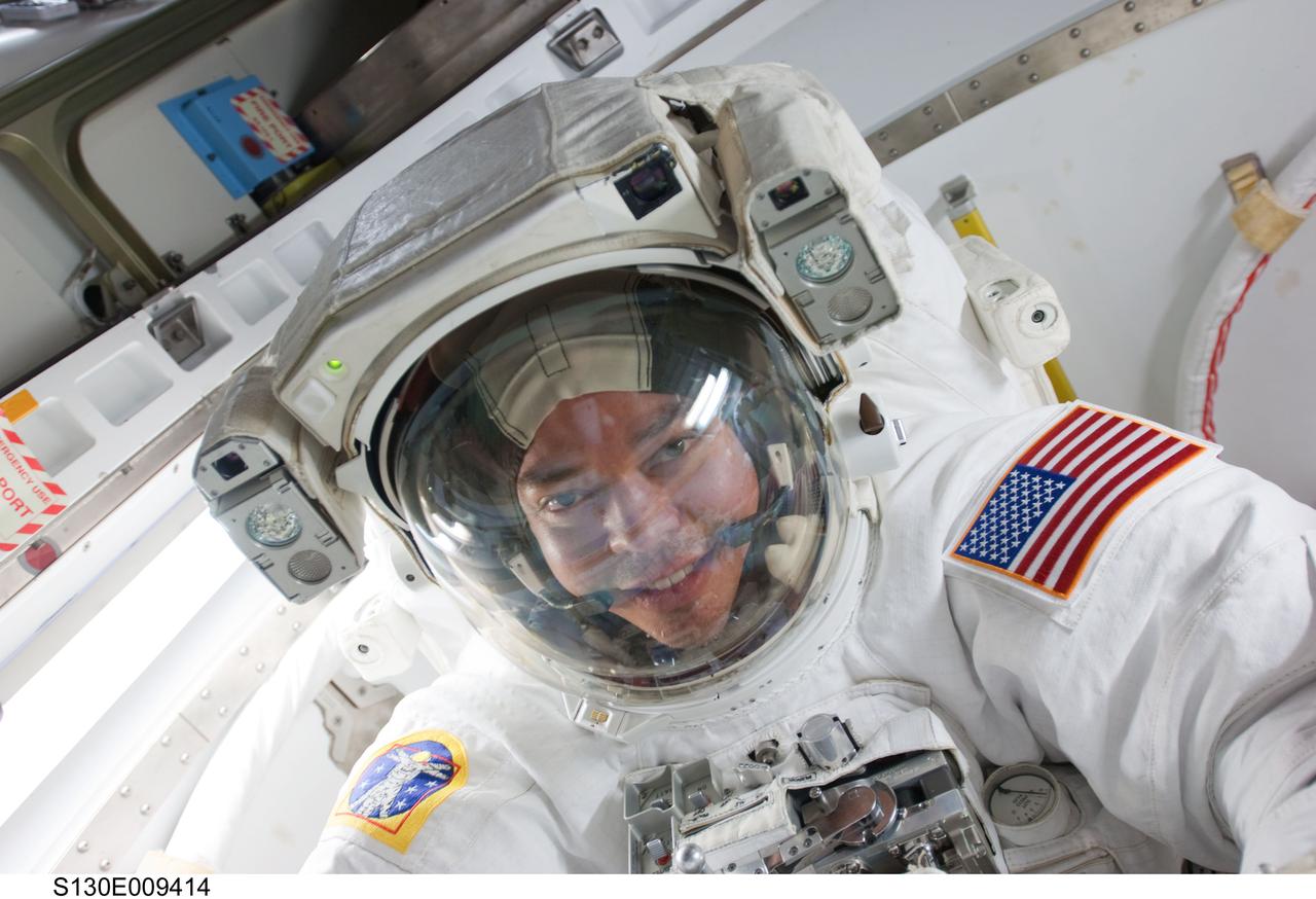 S130-E-009414 (16 Feb. 2010) --- NASA astronaut Robert Behnken, STS-130 mission specialist, attired in his Extravehicular Mobility Unit (EMU) spacesuit, prepares to exit the Quest airlock of the International Space Station to begin the mission's third and final session of extravehicular activity (EVA).