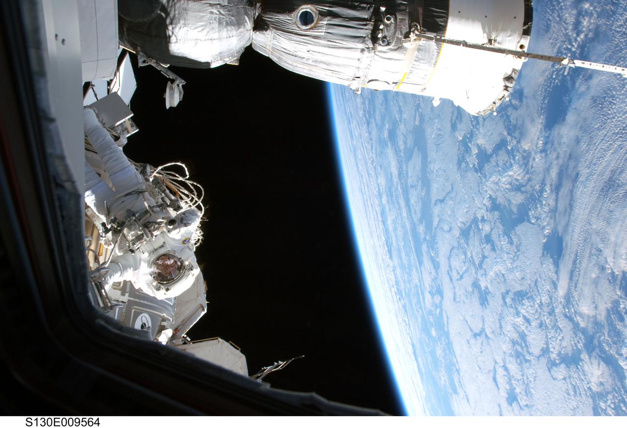 S130-E-009564 (17 Feb. 2010) --- NASA astronaut Nicholas Patrick, STS-130 mission specialist, participates in the mission’s third and final session of extravehicular activity (EVA) as construction and maintenance continue on the International Space Station. During the five-hour, 48-minute spacewalk, Patrick and astronaut Robert Behnken (out of frame), mission specialist, completed all of their planned tasks, removing insulation blankets and removing launch restraint bolts from each of the Cupola’s seven windows. A Russian spacecraft docked to the station is at top.