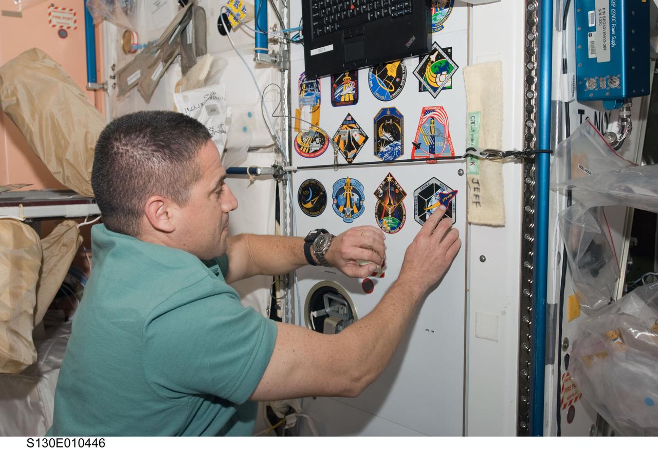S130-E-010446 (18 Feb. 2010) --- NASA astronaut George Zamka, STS-130 commander, adds his crew's patch to the growing collection, in the Unity node, of insignias representing crews who have worked on the International Space Station.