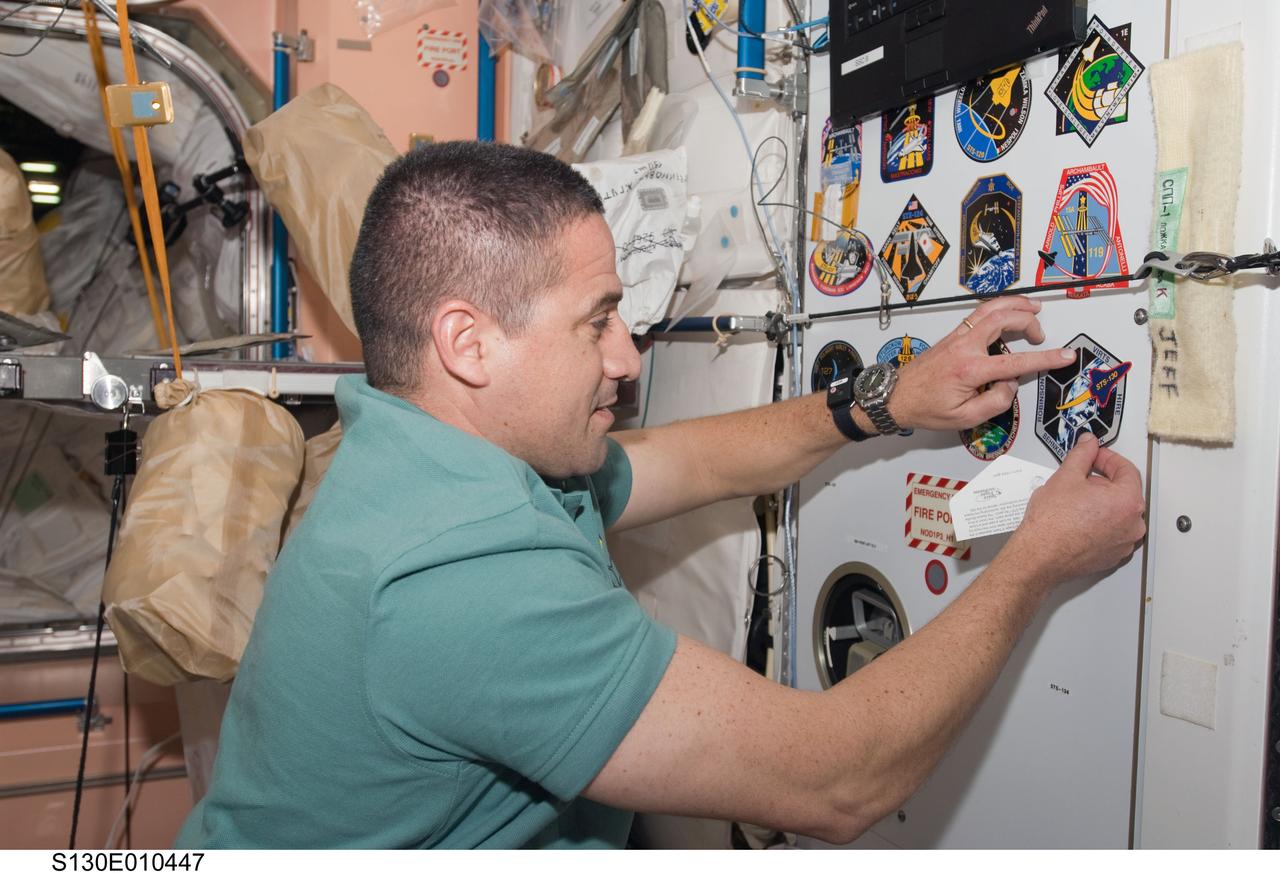 S130-E-010447 (18 Feb. 2010) --- NASA astronaut George Zamka, STS-130 commander, adds his crew's patch to the growing collection, in the Unity node, of insignias representing crews who have worked on the International Space Station.