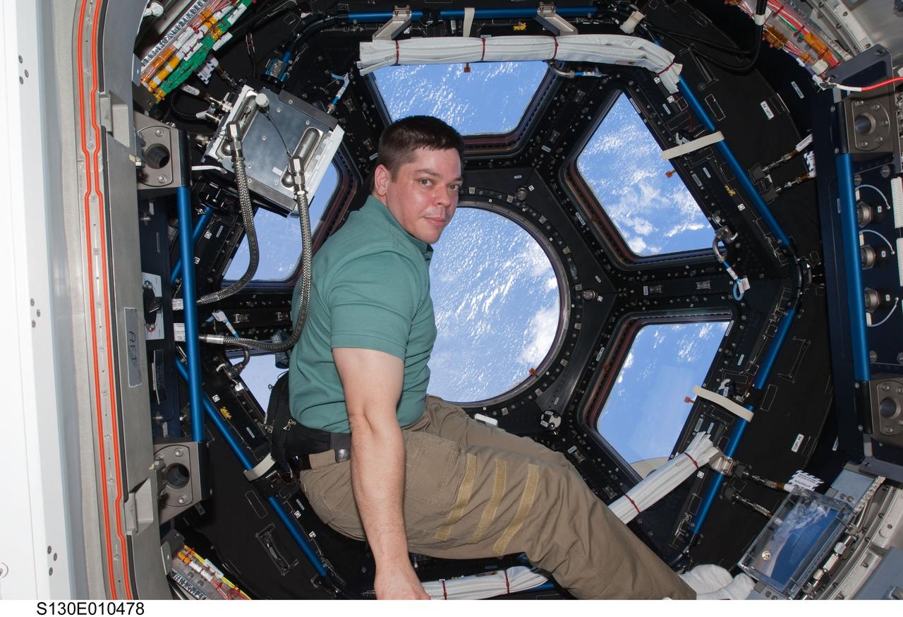 S130-E-010478 (19 Feb. 2010) --- NASA astronaut Robert Behnken, STS-130 mission specialist, is pictured near the windows in the Cupola of the International Space Station while space shuttle Endeavour remains docked with the station.
