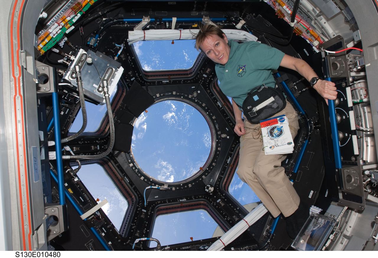 S130-E-010480 (19 Feb. 2010) --- NASA astronaut Kathryn Hire, STS-130 mission specialist, poses for a photo near the windows in the Cupola of the International Space Station while space shuttle Endeavour remains docked with the station.