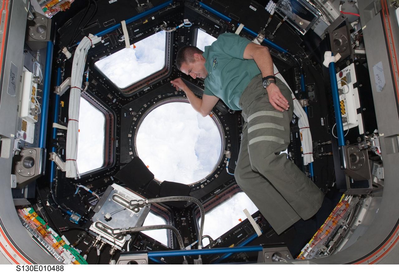 S130-E-010488 (19 Feb. 2010) --- NASA astronaut George Zamka, STS-130 commander, is pictured near the windows in the Cupola of the International Space Station while space shuttle Endeavour remains docked with the station.