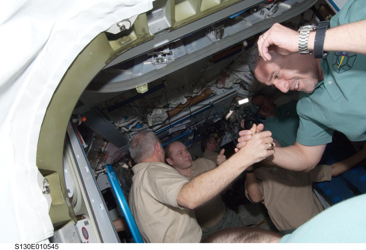 S130-E-010545 (19 Feb. 2010) --- The STS-130 and Expedition 22 crew members gather for a farewell ceremony in the Harmony node of the International Space Station. Pictured are NASA astronauts George Zamka (right), STS-130 commander; and Jeffrey Williams, Expedition 22 commander. Russian cosmonaut Oleg Kotov, Expedition 22 flight engineer, is visible in the background. The hatches between space shuttle Endeavour and the station were closed at 3:08 a.m. (EST) on Feb. 19, 2010.