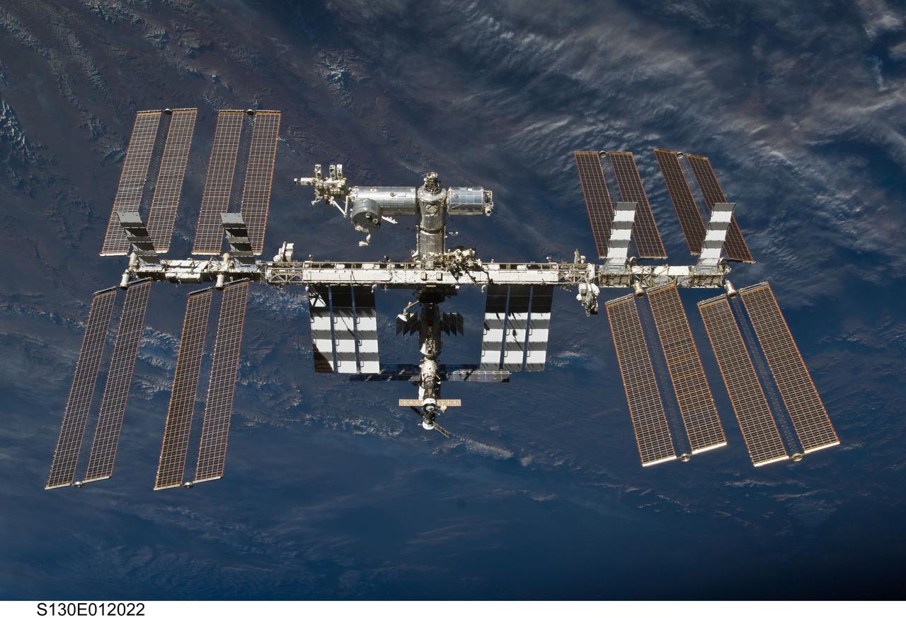 S130-E-012022 (19 Feb. 2010) --- Backdropped by a colorful part of Earth, the International Space Station is featured in this image photographed by an STS-130 crew member on space shuttle Endeavour after the station and shuttle began their post-undocking relative separation. Undocking of the two spacecraft occurred at 7:54 p.m. (EST) on Feb. 19, 2010.