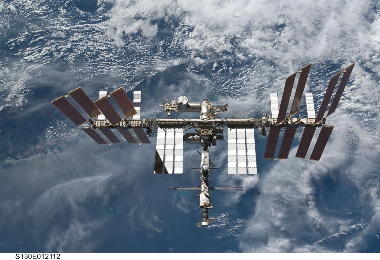 S130-E-012112 (19 Feb. 2010) --- Backdropped by a blue and white part of Earth, the International Space Station is featured in this image photographed by an STS-130 crew member on space shuttle Endeavour after the station and shuttle began their post-undocking relative separation. Undocking of the two spacecraft occurred at 7:54 p.m. (EST) on Feb. 19, 2010.