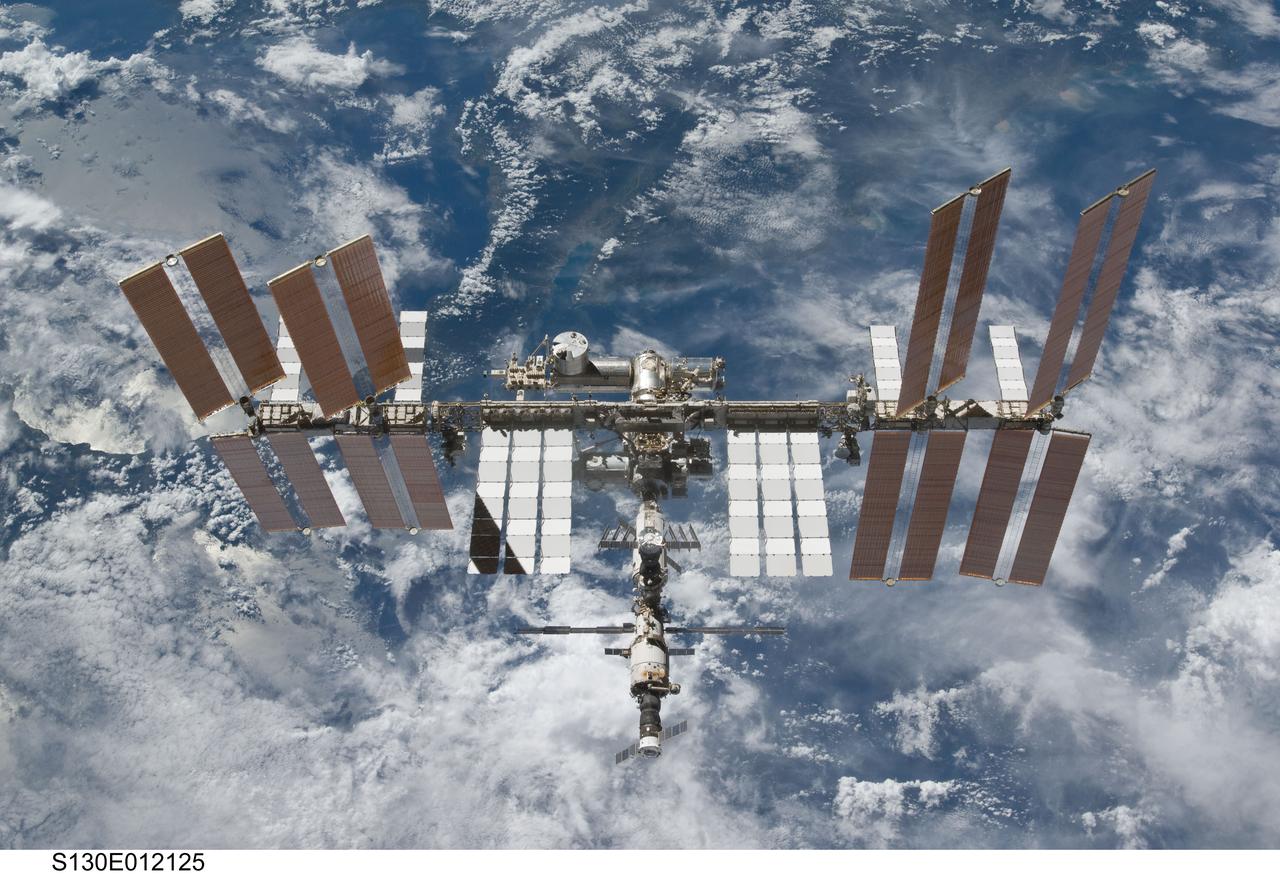 S130-E-012125 (19 Feb. 2010) --- Backdropped by a blue and white part of Earth, the International Space Station is featured in this image photographed by an STS-130 crew member on space shuttle Endeavour after the station and shuttle began their post-undocking relative separation. Undocking of the two spacecraft occurred at 7:54 p.m. (EST) on Feb. 19, 2010.