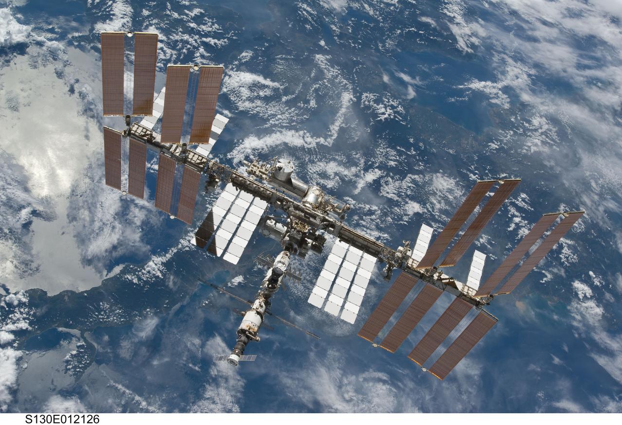 S130-E-012126 (19 Feb. 2010) --- Backdropped by a blue and white part of Earth, the International Space Station is featured in this image photographed by an STS-130 crew member on space shuttle Endeavour after the station and shuttle began their post-undocking relative separation. Undocking of the two spacecraft occurred at 7:54 p.m. (EST) on Feb. 19, 2010.