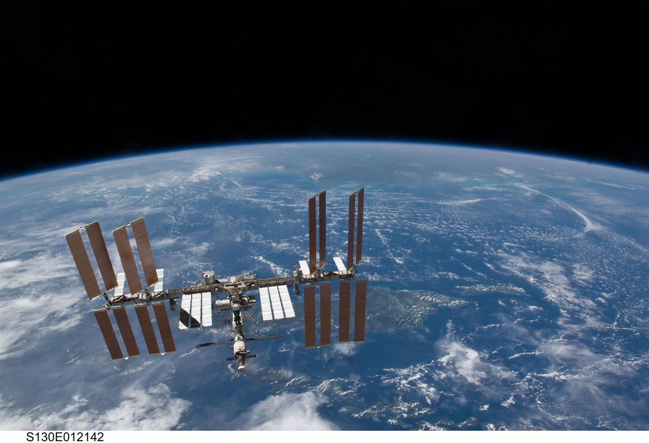 S130-E-012142 (19 Feb. 2010) --- Backdropped by Earth?s horizon and the blackness of space, the International Space Station is featured in this image photographed by an STS-130 crew member on space shuttle Endeavour after the station and shuttle began their post-undocking relative separation. Undocking of the two spacecraft occurred at 7:54 p.m. (EST) on Feb. 19, 2010.