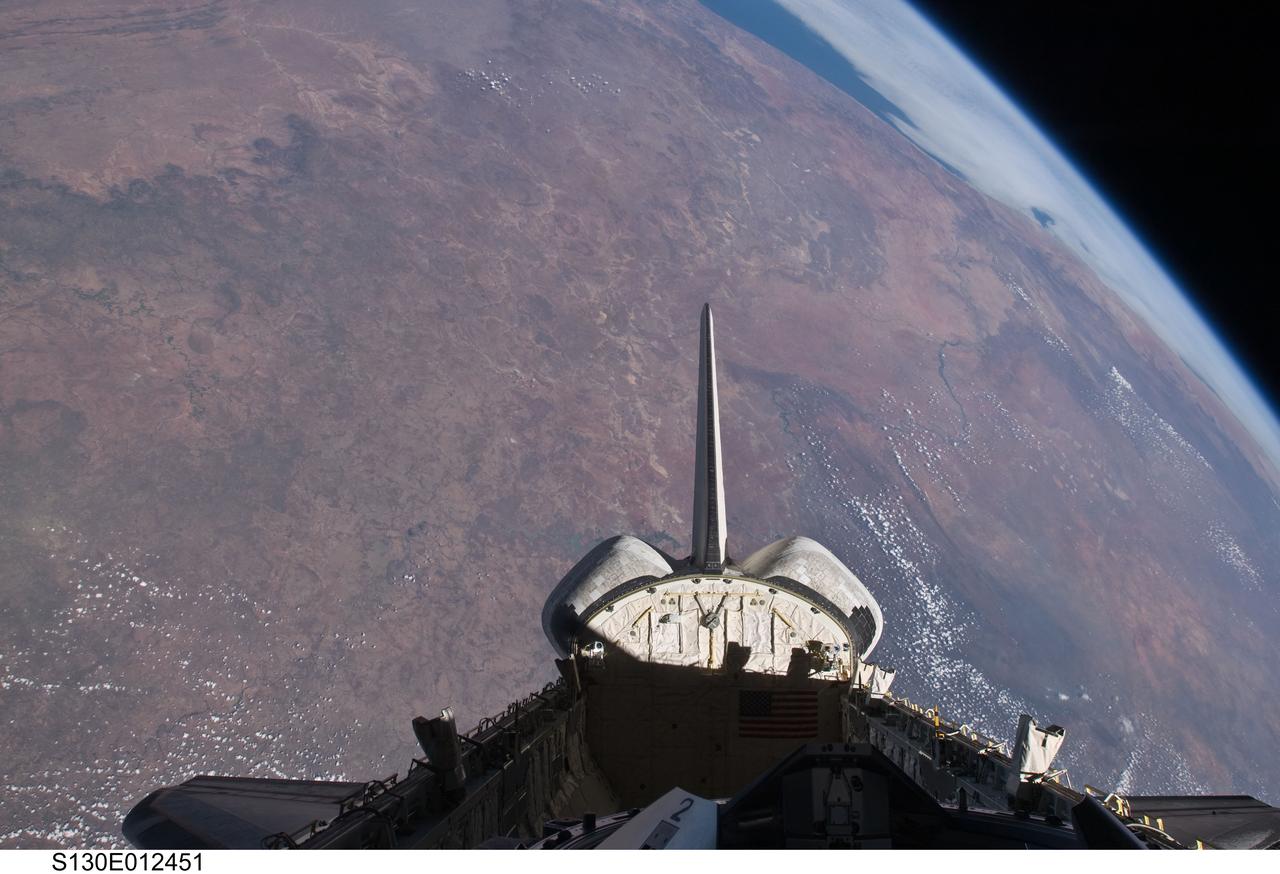S130-E-012451 (20 Feb. 2010) --- The empty cargo bay and the aft portion of the Earth-orbiting space shuttle Endeavour are featured in this image photographed by an STS-130 crew member from inside the spacecraft?s crew cabin. The view is toward the west across southern Africa to the Atlantic ocean. The view follows along the Orange River, which also serves as the border between Namibia (to the right of the river) and South Africa (to the left of the river) nearer to the coast.