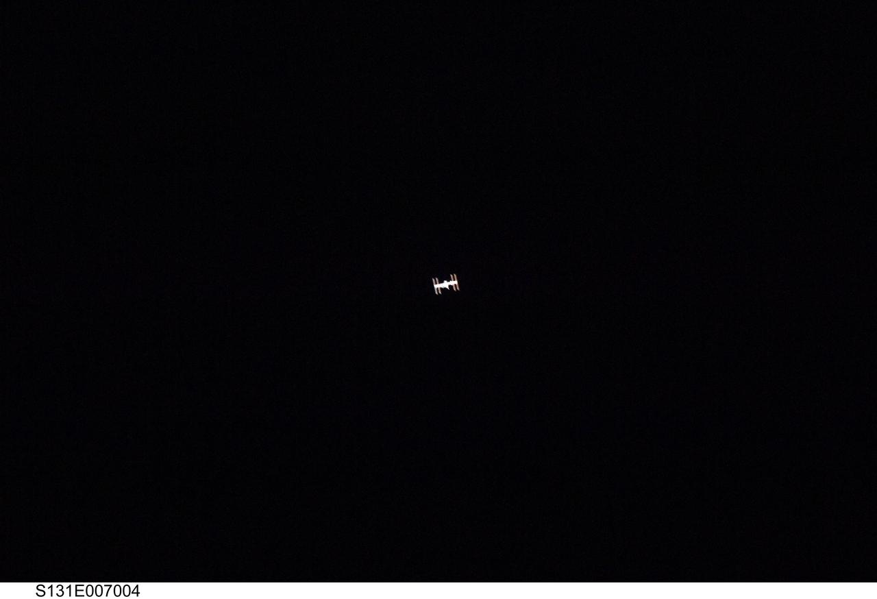 S131-E-007004 (7 April 2010) --- Surrounded by the blackness of space, the International Space Station appears to be very small from the point of view of space shuttle Discovery as the shuttle approaches the station during STS-131 rendezvous and docking operations. Docking occurred at 2:44 a.m. (CDT) on April 7, 2010.