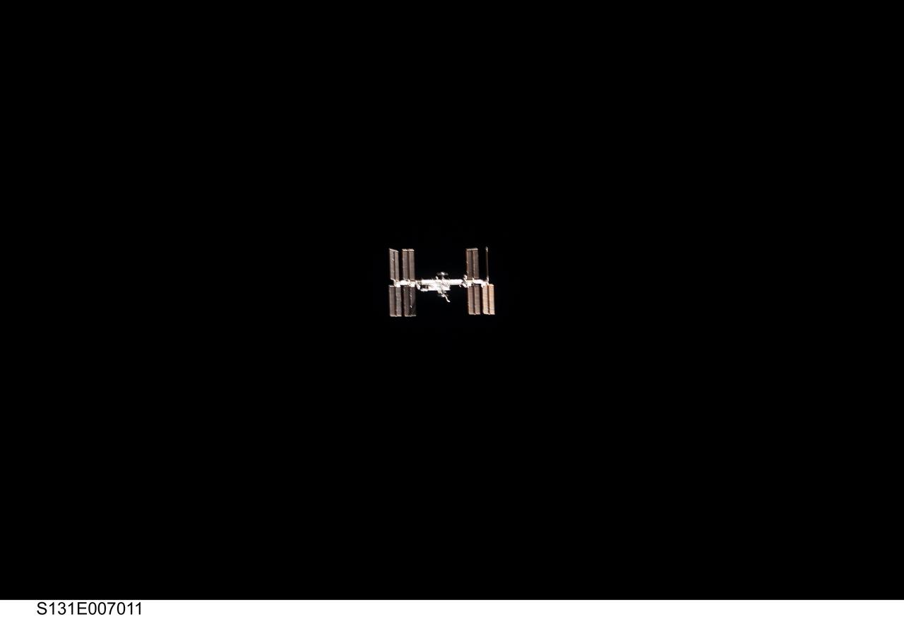 S131-E-007011 (7 April 2010) --- Surrounded by the blackness of space, the International Space Station appears to be very small from the point of view of space shuttle Discovery as the shuttle approaches the station during STS-131 rendezvous and docking operations. Docking occurred at 2:44 a.m. (CDT) on April 7, 2010.