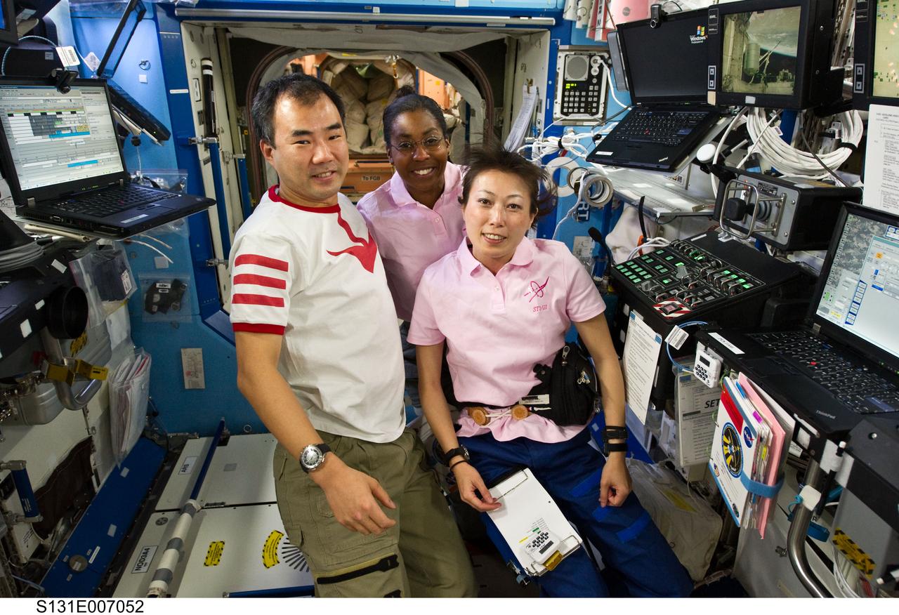S131-E-007052 (7 April 2010) --- Japan Aerospace Exploration Agency (JAXA) astronauts Soichi Noguchi, Expedition 23 flight engineer; and Naoko Yamazaki (right), STS-131 mission specialist; along NASA astronaut Stephanie Wilson, STS-131 mission specialist, pose for a photo in the Destiny laboratory of the International Space Station while space shuttle Discovery remains docked with the station.